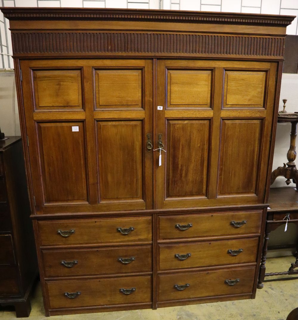 A large late Victorian walnut wardrobe, with fielded panelled doors over six small drawers, width 180cm depth 60cm height 210cm